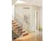 Elegant staircase with carpeted steps, iron railing, and hardwood floors leading to the upper level at 958 S Columbine St, Denver, CO 80209