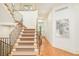 Beautiful staircase featuring patterned carpet, iron railing and window landing to enhance natural light at 958 S Columbine St, Denver, CO 80209