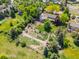 Aerial view of home showcasing the property's mature trees and landscaping with beautiful green grass at 1579 W Costilla Pl, Littleton, CO 80120