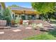 Relaxing backyard with large deck, mature trees, and a rock feature at 1579 W Costilla Pl, Littleton, CO 80120