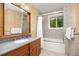 Beautiful bathroom features a tub, shower, window, vanity and is well lit at 1579 W Costilla Pl, Littleton, CO 80120