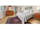 Bedroom with wood floors, a soft bed, and natural light, perfect for relaxation and comfort at 1579 W Costilla Pl, Littleton, CO 80120