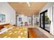 Bright bedroom with wood ceiling, yellow floral bedding, and access to the back deck at 1579 W Costilla Pl, Littleton, CO 80120