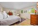 Bright bedroom featuring a large bed, wood furniture, and windows with a view of the outdoors at 1579 W Costilla Pl, Littleton, CO 80120