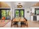 Elegant dining area with modern lighting, sliding glass doors, and views of the outdoor living space at 1579 W Costilla Pl, Littleton, CO 80120