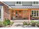 Inviting front porch with brick accents and a modern front door, perfect for enjoying the outdoors at 1579 W Costilla Pl, Littleton, CO 80120