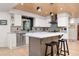 Modern kitchen featuring white cabinets, sleek stainless steel appliances, and a central island with seating at 1579 W Costilla Pl, Littleton, CO 80120