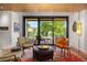 Cozy living area features comfortable seating, stylish décor, and large windows overlooking the lush outdoors at 1579 W Costilla Pl, Littleton, CO 80120