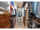 Well-organized walk-in closet with custom shelving, wooden drawers and ample storage space for clothes and accessories at 1579 W Costilla Pl, Littleton, CO 80120