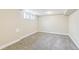 Finished basement with neutral paint, carpet, and natural light from windows at 12020 E Canal Dr, Aurora, CO 80011