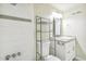 Bathroom featuring tiled shower with shower head and neutral paint, plus vanity at 12020 E Canal Dr, Aurora, CO 80011