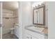 Bathroom features white vanity with modern fixtures and shower with a shower curtain at 12020 E Canal Dr, Aurora, CO 80011