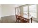 Sunlit dining room area with hardwood floors, natural light, and a view of the backyard at 12020 E Canal Dr, Aurora, CO 80011
