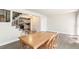 Bright dining room featuring a classic wooden table and stylish staircase to the upper level at 12020 E Canal Dr, Aurora, CO 80011