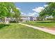 Exterior shot of complex featuring multiple units and lush lawn and sidewalks at 12020 E Canal Dr, Aurora, CO 80011