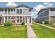 Close up of townhome front entrance with walkway and manicured lawn on a sunny day at 12020 E Canal Dr, Aurora, CO 80011