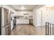 Bright kitchen featuring stainless steel appliances and new white cabinetry for a modern touch at 12020 E Canal Dr, Aurora, CO 80011