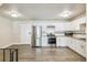 Modern kitchen with stainless steel appliances, white cabinets, and granite countertops at 12020 E Canal Dr, Aurora, CO 80011