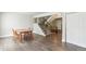 Open-concept living room with hardwood floors, staircase, and neutral wall, ready for personalization at 12020 E Canal Dr, Aurora, CO 80011