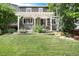 Serene backyard featuring a covered patio with verdant garden beds and plenty of space for outdoor enjoyment and relaxation at 3027 Walnut Grove St, Erie, CO 80516