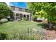 Large backyard with a covered patio area, garden, and mature trees provides a private oasis for outdoor living at 3027 Walnut Grove St, Erie, CO 80516