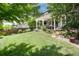 Expansive backyard showcasing a covered patio, landscaped garden beds, and mature trees, creating a peaceful outdoor setting at 3027 Walnut Grove St, Erie, CO 80516