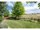 Spacious backyard with beautiful landscaping, mature trees, and a classic wooden fence, offering privacy and serenity at 3027 Walnut Grove St, Erie, CO 80516
