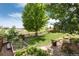 Picturesque backyard featuring a vegetable garden, lush landscaping, and a charming fence, perfect for gardening enthusiasts at 3027 Walnut Grove St, Erie, CO 80516