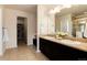 Bathroom boasts double sinks, granite counters, and tile floors with a shower behind a glass door at 3027 Walnut Grove St, Erie, CO 80516