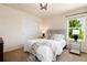 Well-lit bedroom features a comfortable bed, side tables, and modern ceiling light at 3027 Walnut Grove St, Erie, CO 80516