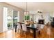 Open-concept dining room featuring hardwood floors, modern light fixture, and access to a patio at 3027 Walnut Grove St, Erie, CO 80516