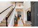 Bright foyer features hardwood floors, staircase, and a view into the living room, creating a warm welcome at 3027 Walnut Grove St, Erie, CO 80516