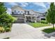 Attractive home showcases lush landscaping, inviting front porch, and an expansive driveway for convenient parking at 3027 Walnut Grove St, Erie, CO 80516