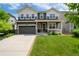 Beautiful two-story home features a well-manicured lawn, spacious driveway, and charming covered front porch at 3027 Walnut Grove St, Erie, CO 80516