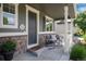 Inviting front porch with stone accents, offers a cozy seating area perfect for enjoying the outdoors at 3027 Walnut Grove St, Erie, CO 80516