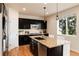Kitchen area with dark cabinetry and stainless steel appliances at 3027 Walnut Grove St, Erie, CO 80516
