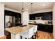 Kitchen with dark cabinets, stainless steel appliances, and a large island with seating at 3027 Walnut Grove St, Erie, CO 80516