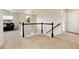 Well-lit upstairs landing with cozy black sofa and staircase with white spindles at 3027 Walnut Grove St, Erie, CO 80516