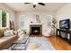 Cozy living room features a stone fireplace, large windows, and stylish decor at 3027 Walnut Grove St, Erie, CO 80516
