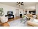 Bright and airy living room with hardwood floors and modern furnishings at 3027 Walnut Grove St, Erie, CO 80516
