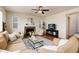 Comfortable living room features a stone fireplace, large windows, and stylish decor at 3027 Walnut Grove St, Erie, CO 80516