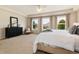 Comfortable main bedroom with ample natural light from three large windows and neutral decor at 3027 Walnut Grove St, Erie, CO 80516