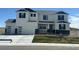 Charming two-story home with a three-car garage, blue roof accents, and landscaped yard at 42980 Colonial Trl, Elizabeth, CO 80107