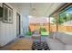 Inviting back porch features a seating area and view of the backyard at 1650 S Holly St, Denver, CO 80222