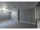 A neutral basement with carpeted floors, offering a versatile space at 1650 S Holly St, Denver, CO 80222