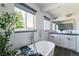 Elegant bathroom featuring a soaking tub, dual sinks, and subway tile at 1650 S Holly St, Denver, CO 80222