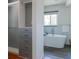 Luxurious bathroom featuring a stand-alone soaking tub, modern tile, and a custom walk-in closet at 1650 S Holly St, Denver, CO 80222