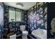 Charming powder room with unique wallpaper, complemented by modern fixtures at 1650 S Holly St, Denver, CO 80222