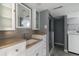 Modern bathroom with stone countertops, glass shower, and stylish decor at 1650 S Holly St, Denver, CO 80222