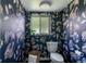 Charming powder room with animal themed wallpaper, complemented by modern fixtures at 1650 S Holly St, Denver, CO 80222